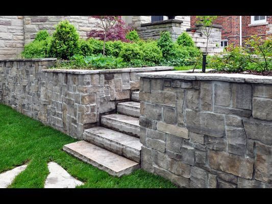 Grey stone retaining wall flanking middle steps in Oakville, Ontario